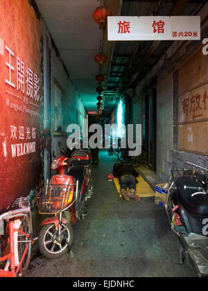 Homeless person sleeps on the streets of Shanghai, China Stock Photo