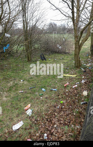 Litter, trash, plastic, glass, bottles, cans, bags and fast food cartons around a council estate in Bradford, West Yorkshire. Stock Photo