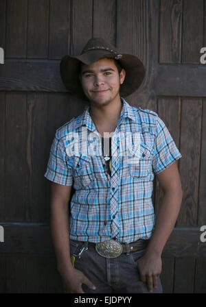 A young man poses in cowboy hat. Stock Photo