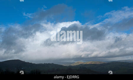 Carmarthenshire, Wales, UK. 24th March, 2015. UK Weather: Heavy clouds laden with cold rain and hail break to let sunshine stream onto the landscape in Carmarthenshire West Wales near Llandovery UK. Credit:  Kathy deWitt/Alamy Live News Stock Photo