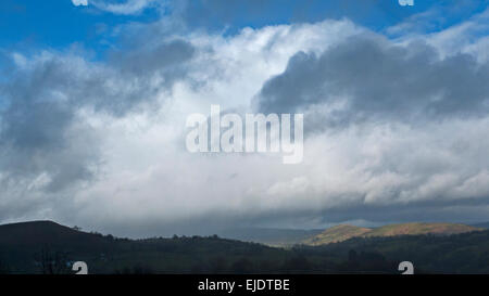 Carmarthenshire, Wales, UK. 24th March, 2015. UK Weather: Heavy clouds laden with cold rain and hail break to let sunshine stream onto the landscape in Carmarthenshire West Wales near Llandovery UK. Credit:  Kathy deWitt/Alamy Live News Stock Photo