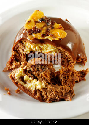 Cake with a pattered chocolate case and piped chestnut puree with cumquat sauce, in a modern designer dish