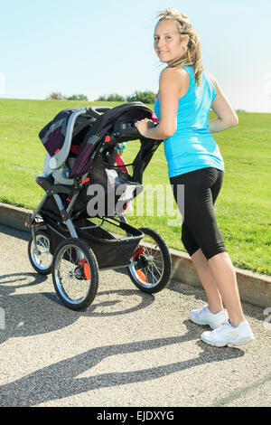 A mother training with baby on a summer day Stock Photo