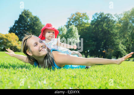 A mother training with baby on a summer day Stock Photo