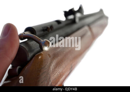 Thumb on a rifle bolt Stock Photo