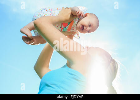 A mother training with baby on a summer day Stock Photo