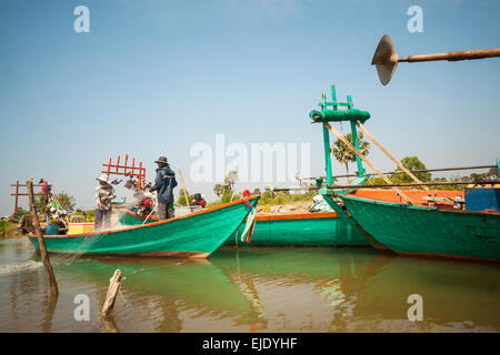 Fishing activities in Cambodia, Asia. Family pulling fishing net from the river hear Kep, Kep province. Stock Photo