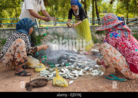 Fishing activities in Cambodia, Asia. A family sorting fish for sale. Stock Photo