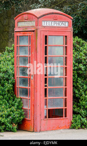 British Telecom K6 model red telephone box (payphone kiosk) in poor condition, Grade II listed, in Littlehampton, West Sussex, England, UK. Stock Photo
