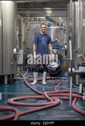 Member of Staff Holding Barrel inside Camden Brewery London Stock Photo