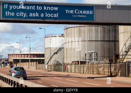 The Courier advertisement banner on a bridge walkway leading to the large oil storage tanks in Dundee, UK Stock Photo