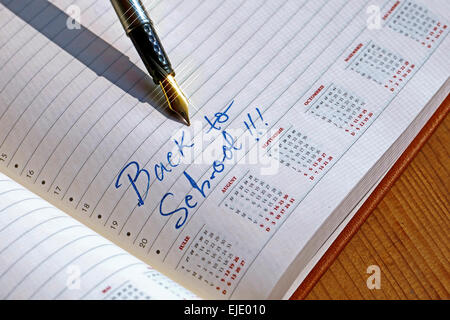 Open diary with one fountain pen that write BACK TO SCHOOL. Stock Photo