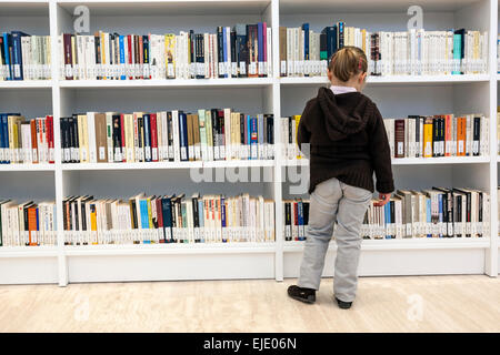 Little girl browsing books. Library and Archive of Galicia. The City of Culture of Galicia designed by architect Peter Eisenman. Stock Photo