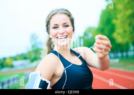 A Runner woman jogging on a field outdoor shot Stock Photo