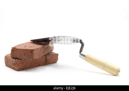 isolated of construction lute trowel with red brick on white Stock Photo