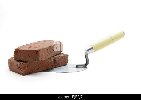 Studio shot of construction lute trowel with red brick isolated on white Stock Photo