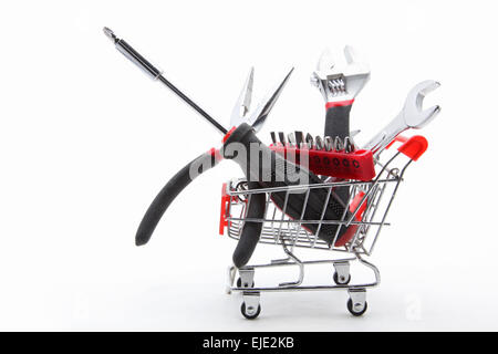 collection of construction tools and equipment inside a shopping cart Stock Photo