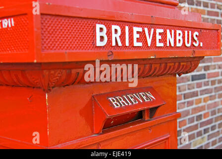 Old red post box at Zaanse Schans north of Amsterdam Stock Photo