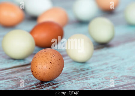 Assortment of different color, fresh chicken eggs on vintage green wooden background Stock Photo