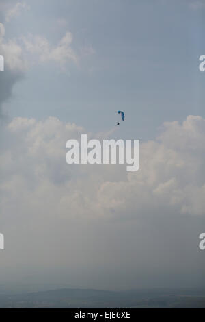 Paraglider in the sky in front of clouds. Wasserkuppe, Rhoen Mountains, Germany Stock Photo