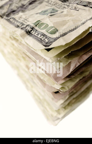 Money and finance: stack of old and crumpled one-hundred dollar bills, isolated on white background. Not a real banknotes. Stock Photo