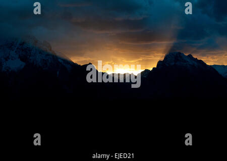 sunset behind Teton Mountains in Grand Teton National Park Stock Photo