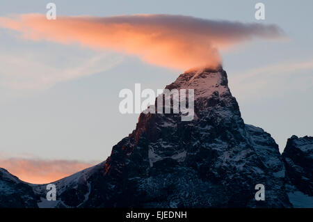 Lenticular cloud at sunset over Grand Teton Mountain Peak Stock Photo