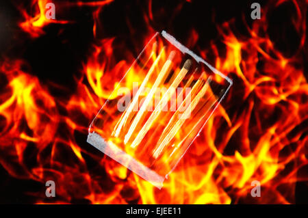 Box of matches superimposed with fire in studio setting Stock Photo