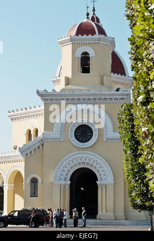 A funeral procession leaves the main chapel at the Colon Cemetery, or Cementerio de Cristóbal Colón, founded in 1876 in Havana. The cemetery houses more than 800,000 graves and 1 million interments. After three years remains are removed from their tombs, boxed and placed in a storage building. Stock Photo