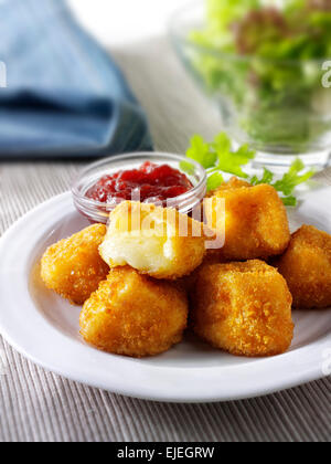 Deep fried camembert cheese in bread crumbs with salad Stock Photo