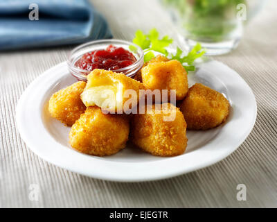 Deep fried camembert cheese in bread crumbs with salad Stock Photo