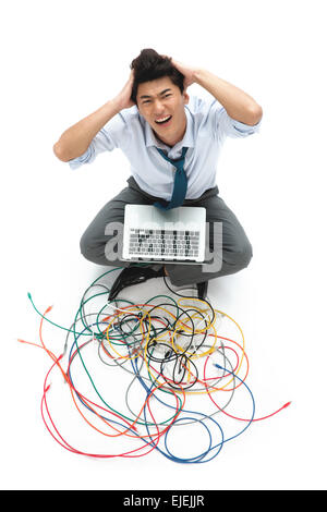 When using computer business man hands scratching his head Stock Photo