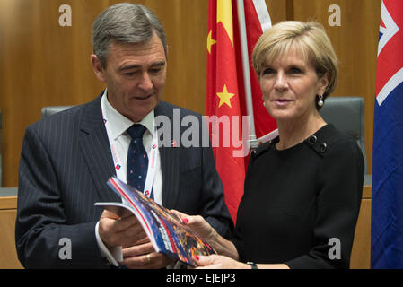 Canberra, Australia. 25th Mar, 2015. Australian Foreign Minister Julie Bishop (R) and National President of Australian China Business Council (ACBC) John Brumby attend the launching meeting of ACBC's 2014 Australia-China Trade Report at the Parliament House in Canberra, Australia, March 25, 2015. Australia's direct trade with China, its largest trading partner, has accounted for 5.5 percent of the country's Gross Domestic Product (GDP) in 2014, according to a report on bilateral trade which was launched in the Parliament House in Canberra on Wednesday. Credit:  Justin Qian/Xinhua/Alamy Live Ne Stock Photo