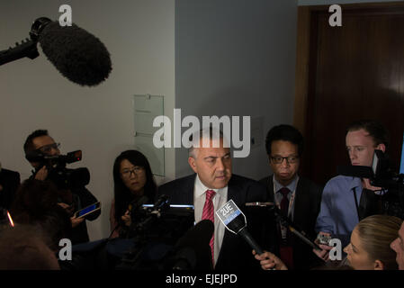 Canberra, Australia. 25th Mar, 2015. Australian Treasurer Joe Hockey (C) speaks to the media after the launching meeting of Australian China Business Council (ACBC)'s 2014 Australia-China Trade Report at the Parliament House in Canberra, Australia, March 25, 2015. Joe Hockey, an early proponent of the bank in Australia, said on Wednesday Australia would do its best to meet next Tuesday's deadline. Credit:  Justin Qian/Xinhua/Alamy Live News Stock Photo