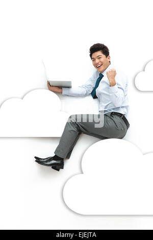 The business man sat holding a notebook computer in the cloud