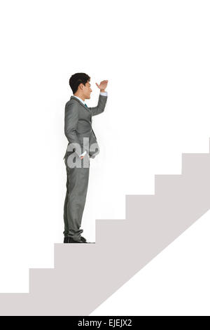 Creative business man standing on the steps overlook Stock Photo