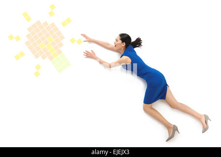 Business young woman reached out to grab the electric light bulb Stock Photo