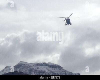 Seyne Les Alpes, France. 25th March, 2015. A helicopter flies to the crash site of Germanwings A320 plane in the Alps in southern France, March 25, 2015. French gendarmes late Tuesday found one of the two black boxes of the German passenger plane that crashed in southern France with 150 people on board, while a joint international probe into the cause of the accident is under way. Credit:  Xinhua/Alamy Live News Stock Photo