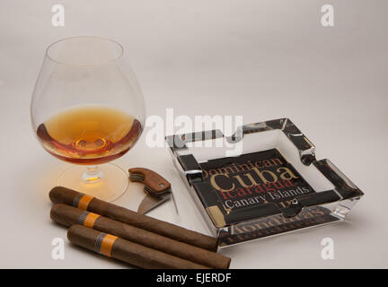 still life glass of brandy and Cuban cigars Stock Photo