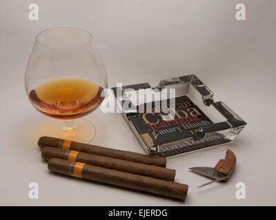 still life glass of brandy and Cuban cigars Stock Photo