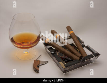 still life glass of brandy and Cuban cigars Stock Photo