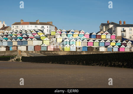 part of the sandy beach at Walton-on-the-Naze with a colourful selection of beach huts behind. They are close to the pier.. Stock Photo