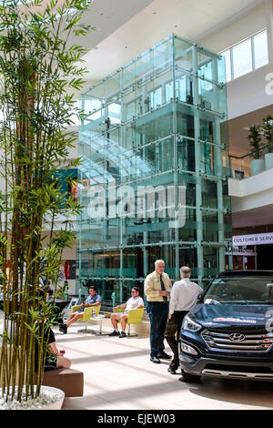 The glass elevator in the background at the new University Town Center Mall located on University Parkway in Sarasota FL Stock Photo