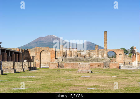 Ruined Temple of Jupiter with mount vesuvio in Pompeii. Pompeii is a ruin of acient Roman City near Naples in Italy. Stock Photo