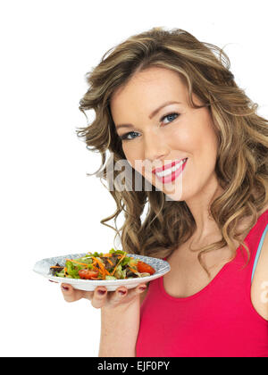 Healthy Young Woman Eating a Fresh Crispy Garden Salad Stock Photo