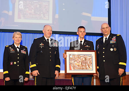 From left, U.S. Army Gen. Ann E. Dunwoody, Gen. Robert W. Cone, and Army Chief of Staff Gen. Raymond T. Odierno, right, present the 2011 Male Athlete of the Year Award to 1st Lt. Charles Ware III at the Association of the U.S. Army Winter Symposium in Ft. Lauderdale, Fl.  Feb. 24, 2012.  Dunwoody is the commanding general, U.S. Army Materiel Command; and Cone is the commanding general, U.S. Army Training and Doctrine Command.  Staff Sgt. Teddy Wade Stock Photo