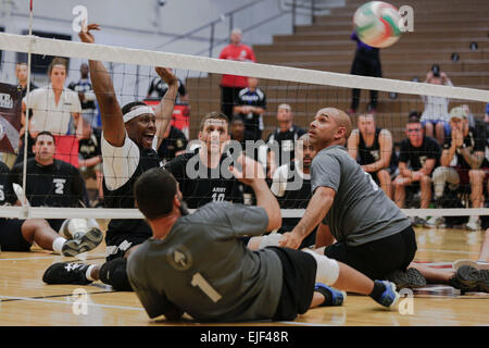 Retired U.S. Army Staff Sgt. Alexander Shaw, Clarksville, Tenn., a member of the Army team, reacts to hitting the ball during the first sitting volleyball game against the U.S. Special Operations Command team during the 2014 Warrior Games at the U.S. Olympic Training Center, Colorado Springs, Colo., Sept. 29, 2014. More than 200 service members and veterans participate in the 2014 Warrior Games, an annual event where wounded, ill and injured warriors compete in various Paralympic-style events.   Sgt. Sara Wakai Stock Photo