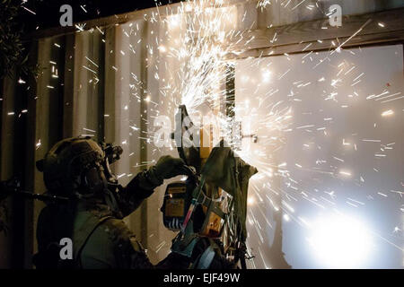 The 7th Special Forces Group  A Green Beret assigned to the 7th Special Forces Group Airborne uses a power saw to cut through locks securing a door during a training mission held February 20 on Team Eglin Air Force Base in Northwest Florida. The mission required a team of Special Forces soldiers to assault a mock drug-cartel outpost and document sensitive materials found inside. Stock Photo