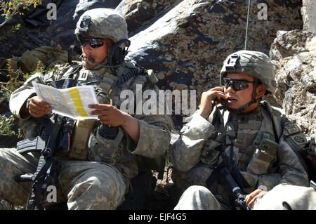 U.S. Army Capt. Christopher Demure, commander of 2nd Battalion, 508th Parachute Infantry Regiment, checks his terrain card and checklist as 1st Lt. John Morris maintains communications while searching mountains in the Andar province of Afghanistan for Taliban members and weapons caches June 6, 2007.  Staff Sgt. Marcus J. Quarterman Stock Photo