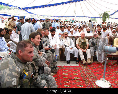 Army Capt. Christopher Hormel of Spokane, Wash. and his team, including Ohio native, Army 1st Lt. Leah Wicks, and Army 2nd Lt. James Hardy from Louisville, Ky., all officers of the 66th Military Police Company stationed out of Fort Lewis, Wash., attend the Afghan Independence Day ceremony at Torkham Gate on 19 Aug. Stock Photo